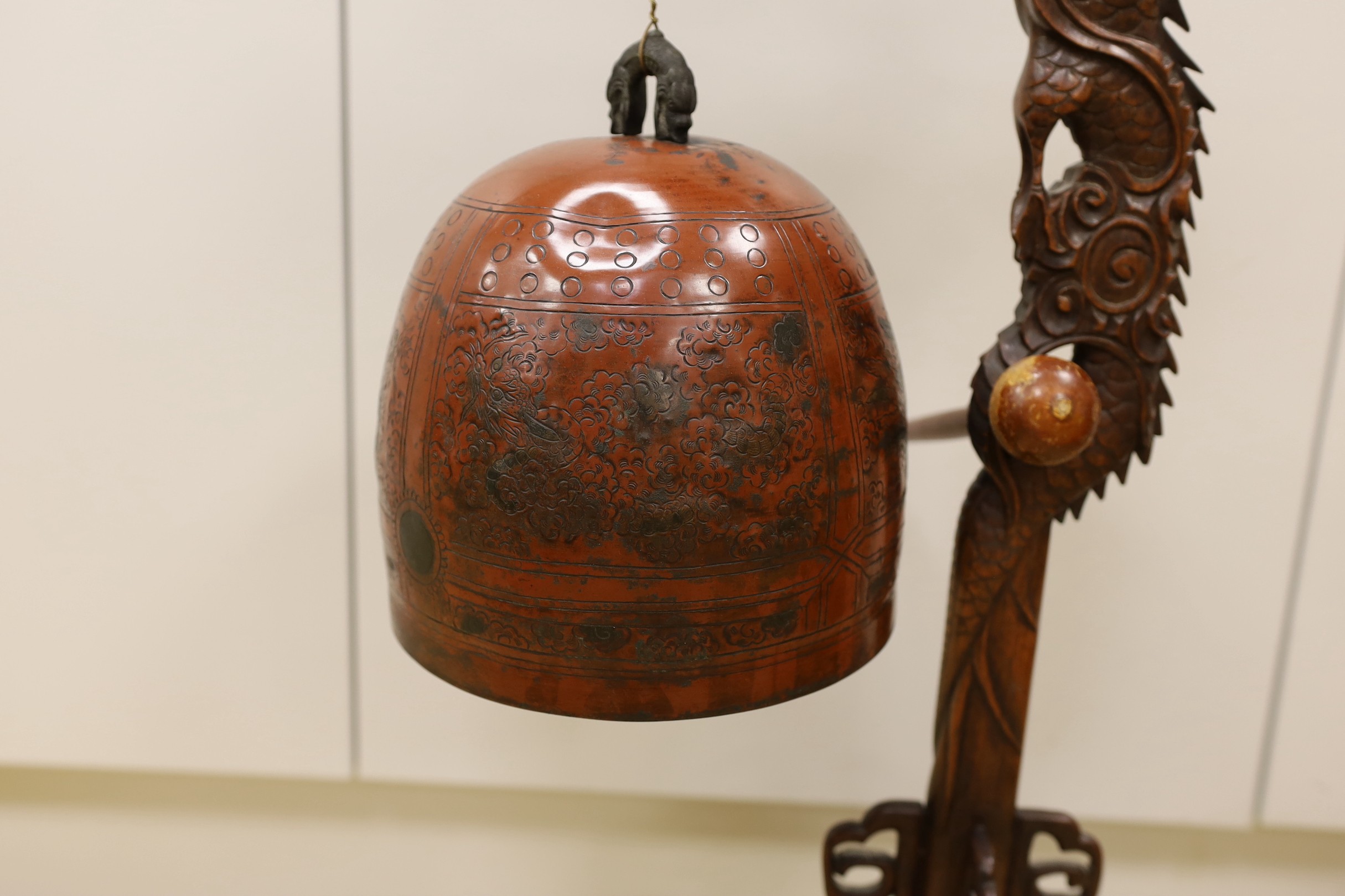 A Chinese carved hongmu 'dragon' stand with Japanese bell, 73cm tall